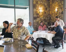  ??  ?? Above: Restaurant partner Ali Gulczynski pours wine for a table during a dinner seating at Michael Warring in Vallejo. The restaurant offers a six-course tasting menu with an option for wine or beer pairings. Below: A dish of ribeye with maiitake...