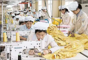  ?? HEEJIN KOO/BLOOMBERG 2007 ?? North Korean workers sew at South Korean Shinwon Corp.’s operations in North Korea. Foreign direct investment is tiny.