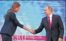  ?? AP ?? Vladimir Putin shakes hands with a TV host as he arrives for his annual televised callin show in Moscow on Thursday.