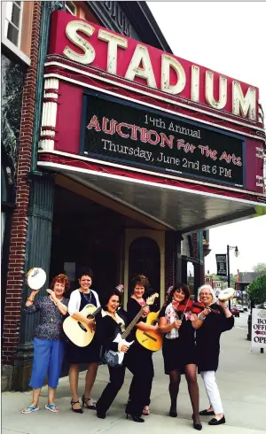  ?? Submitted photo ?? The Stadium Theatre’s auction team, from left, Kathy Jasmin, Diane Landry, Cathy Levesque, Anne Choquette, Michelle Pezza and Beverly Russell, pose with instrument­s signed by musicians who have performed at the Woonsocket theatre, including Charlie Daniels, Clint Black, Doug Gray and Lee Ann Womack.