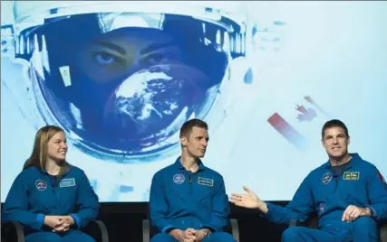  ?? GRAHAM HUGHES, THE CANADIAN PRESS ?? Canada’s newest astronauts Jennifer Sidey and Joshua Kutryk speak with astronaut Jeremy Hansen, right, during a visit to the Canadian Space Agency.