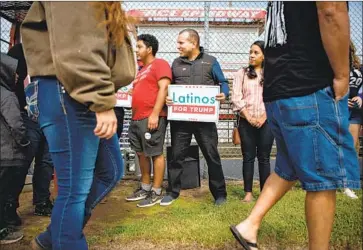  ?? VENEZUELAN I MMIGRANT Photog r aphs by Jason Armond Los Angeles Times ?? Omar Lugo, center, founder of Latinos for Trump of Alamance County, gathers with other Latino supporters of President Trump during a rally at Ace Speedway last month in Elon, N. C.