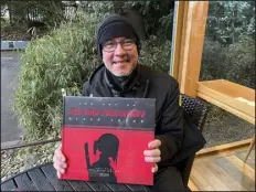  ?? YURI KAGEYAMA — THE ASSOCIATED PRESS ?? Japanese pop culture expert Roland Kelts holds a book about Blade Runner at Meiji Jingu in Tokyo on Feb. 25. Hit Japanese manga “One Piece” is coming to Netflix as a liveaction series.