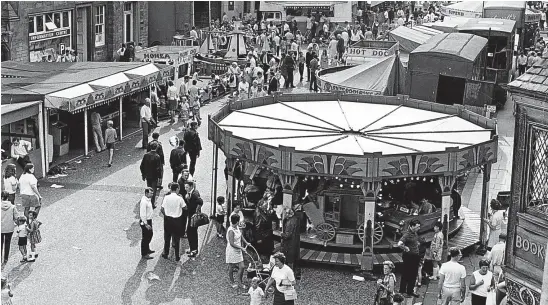  ??  ?? This photograph, taken from our archive, shows a busy scene at the Lammas Market in St Andrews. The picture was taken in 1969.