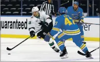  ?? SCOTT KANE — THE ASSOCIATED PRESS ?? San Jose Sharks’ Kevin Labanc, left, handles the puck in front of St. Louis Blues’ Torey Krug during the first period Saturday.