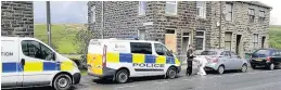  ??  ?? Police at the scene of the fire on Burnley Road, Loveclough