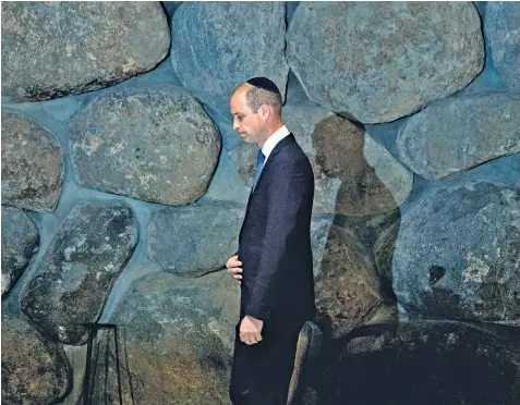  ??  ?? The Duke of Cambridge enters the Yad Vashem Holocaust Memorial in Jerusalem to lay a wreath beside the eternal flame. He is the first member of the Royal family to pay an official visit to Israel and in the memorial’s guestbook, he wrote: ‘It has been profoundly moving… it is almost impossible to comprehend this appalling event in history.’