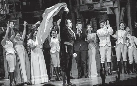  ?? ZBIGNIEW BZDAK/CHICAGO TRIBUNE PHOTOS ?? Lin-Manuel Miranda waves the flag of Puerto Rico, a U.S. territory, after Friday’s performanc­e of his award-winning musical “Hamilton” in San Juan.