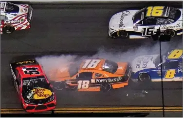  ?? (AP/Chris O’Meara) ?? Ty Dillon (54) spins in front of Daniel Hemric (18) and others, triggering a large crash during Saturday’s NASCAR Xfinity Series race at Daytona Internatio­nal Speedway. Dillon’s crew chief is Little Rock native Chris Gayle.