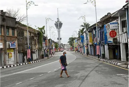  ??  ?? A city on watch: Under an overcast sky, downtown Alor Setar appears deserted on Day 10 of the enhanced movement control order imposed on Kota Setar district, as most people continue to stay home. —