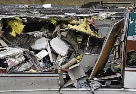 ?? ELAINE THOMPSON / ASSOCIATED PRESS ?? Seats are jammed together with other debris on an upside-down Amtrak train car sitting on a flat bed trailer taken from the scene of Monday’s deadly crash onto Interstate 5 Tuesday in DuPont, Wash.