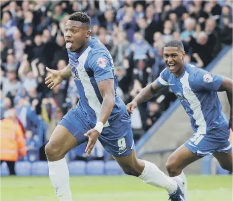  ??  ?? Britt Assombalon­ga after scoring for Posh against Leyton Orient in a League One play-off semi-final at London Road in 2014.