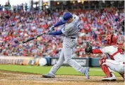  ?? AP ?? Freddie Freeman did as much as anyone to hand the Reds a fourth straight loss Tuesday, here belting a tworun double in the third on his way to a five-RBI night.