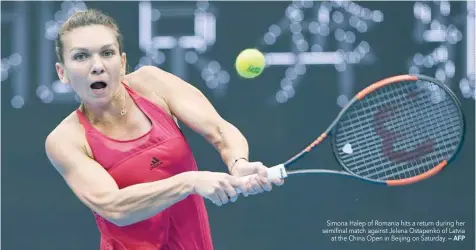  ?? — AFP ?? Simona Halep of Romania hits a return during her semifinal match against Jelena Ostapenko of Latvia at the China Open in Beijing on Saturday.