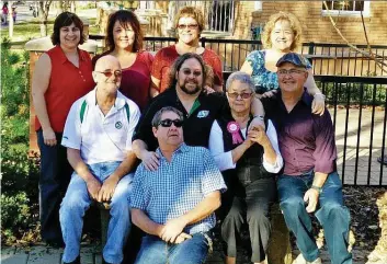  ?? PHOTOS: COURTESY OF DONNA PEARCE ?? Donna Pearce, back row, far left, and other family members mark the occasion of Norma Welsh’s, centre with pink ribbon, 80th birthday. Pearce’s adoption story is a successful one,