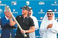  ?? AFP ?? Danny Willett of England holds the trophy after winning the DP World Tour Championsh­ip at Jumeirah Golf Estates in Dubai on Sunday.