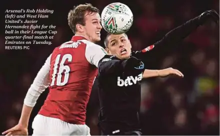  ?? REUTERS PIC ?? Arsenal’s Rob Holding (left) and West Ham United’s Javier Hernandez fight for the ball in their League Cup quarter-final match at Emirates on Tuesday.