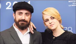  ?? Joel C Ryan / Associated Press ?? Pablo Larrain, left, and Kristen Stewart pose at the photo call for the film “Spencer” during the 78th edition of the Venice Film Festival.