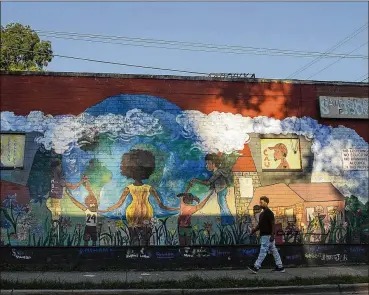  ?? ALYSSA POINTER / ALYSSA.POINTER@AJC.COM ?? Ashview Heights resident Melody Cook-Blount worked with other residents to find help for repeat offender Angela Dalton. “I love the neighborho­od. I believe you have a right to like where you live,” she said. A mural on St. Joseph Street Southwest depicts neighborho­od life and historical­ly black colleges at nearby Atlanta University Center.