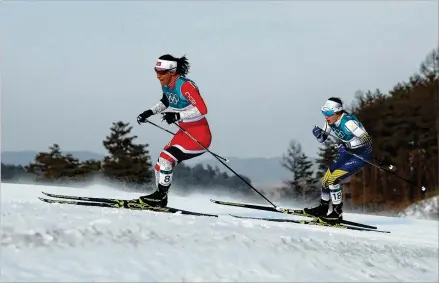  ?? CLIVE MASON / GETTY IMAGES ?? Cross-country skier Marit Bjoergen of Norway (left), competing in her fifth Olympics, added a silver medal to her collection Saturday and is the most decorated female Winter Olympian ever with 11 medals. Norway has won 329 all-time Winter Games medals.