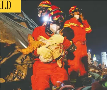  ?? STR / AFP VIA GETTY IMAGES ?? A boy is rescued from the rubble of a hotel in Quanzhou, China on Sunday. Ten people have died and 23 remain
trapped after the building, being used as a coronaviru­s quarantine facility, caved in.