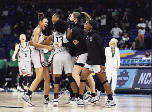  ?? Elsa / Getty Images ?? UConn celebrates the win over Baylor after the Elite Eight round of the Women’s NCAA Tournament at the Alamodome on Monday in San Antonio, Texas. The UConn defeated Baylor 69-67 to advance to the Final Four.