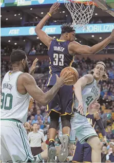  ?? STAFF PHOTO BY MATT STONE ?? PASSING FANCY: Kelly Olynyk makes a pass around Pacers center Myles Turner to Celts teammate Amir Johnson during last night’s game.