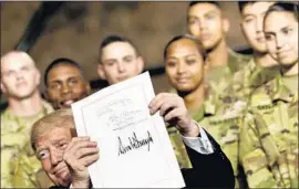  ?? Brendan Smialowski AFP/Getty Images ?? PRESIDENT TRUMP after signing the John S. McCain National Defense Authorizat­ion Act, a $716-billion defense bill named for the ailing Arizona senator.