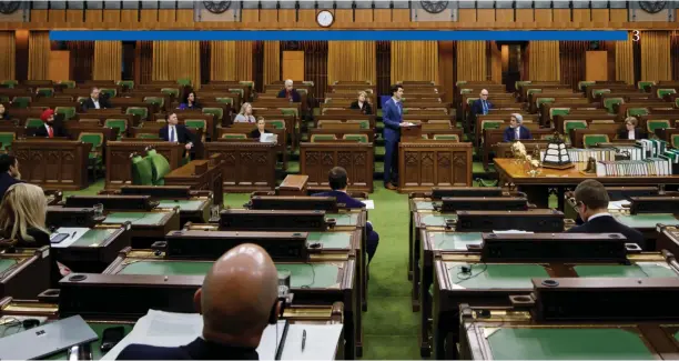  ?? Adam Scotti photo ?? Prime Minister Justin Trudeau speaks to the House and the country during an unpreceden­ted sitting Easter Saturday on the government’s emergency job legislatio­n. By all-party agreement, only 30 MPs attended for a bare quorum necessary to pass Bill C-14.