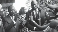  ??  ?? President Alassane Ouattara (L) waves to supporters after voting in the Cocody residentia­l district of Abidjan