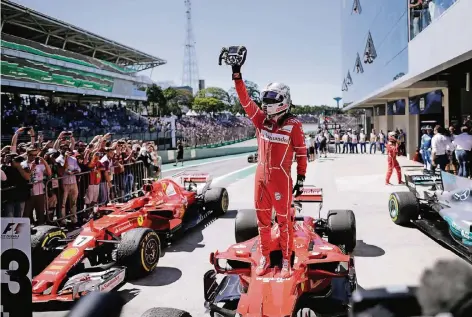  ?? FOTO: REUTERS ?? Sebastian Vettel zeigt den Fans das Lenkrad seines Ferrari, in dem er in Sao Paulo gewann. Es ist sein 47. Grand-Prix-Sieg in der Formel 1.