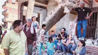  ?? Solafa Salam ?? Al-Warraq residents in the rumble of demolished buildings as government promises no evacuation of island