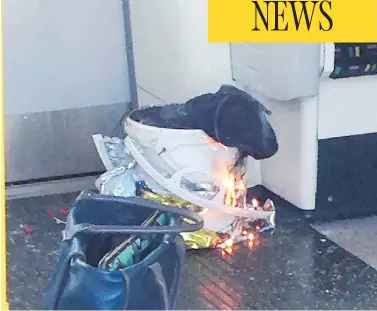  ?? AFP / GETTY IMAGES ?? A plastic bucket burns inside a London subway train on Friday. The bucket is believed to contain a bomb, packed with nuts, bolts and nails, used by terrorists that injured more than 20 train passengers. The main explosive charge failed to go off,...