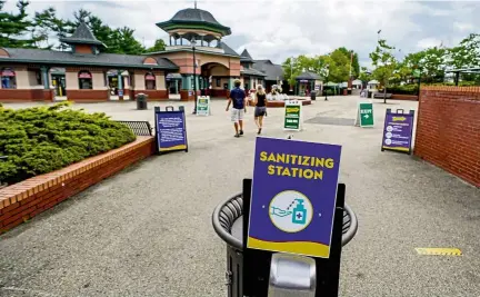  ?? — AP ?? Visitors have been slow to return to theme parks in the US, even though many operators have put in place extra safety measures like sanitising stations.