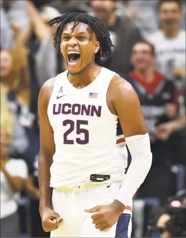  ?? Stephen Dunn / Associated Press ?? UConn’s Josh Carlton screams after blocking a shot in the second half against Sacred Heart.