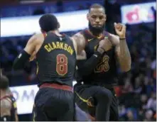  ?? SUE OGROCKI — THE ASSOCIATED PRESS ?? Cleveland’s LeBron James (23) celebrates with teammate Jordan Clarkson during the second half of the team’s game against the Thunder in Oklahoma City, Tuesday.