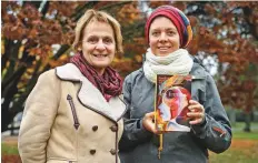  ?? AFP ?? Geneva theology professors Elisabeth Parmentier (left) and Lauriane Savoy pose with an edition of ‘A Women’s Bible’ in Geneva, which was published in October.