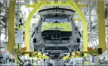  ?? ZHUANG GE’ER / FOR CHINA DAILY ?? Employees work on the production line of a carmaker in Yibin, Sichuan province.