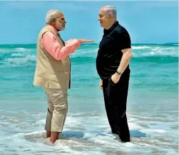  ?? —PTI ?? Prime Minister Narendra Modi with his Israeli counterpar­t Benjamin Netanyahu during a visit to the Olga Beach in Israel on Thursday.