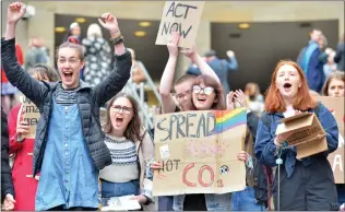  ??  ?? Climate change protesters on the steps of the Royal Concert Hall