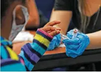  ?? Ronald Cortes / Contributo­r ?? A young student prepares to swab her nose to receive a COVID test Sunday from Community Labs, a San Antonio nonprofit.