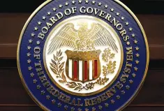  ??  ?? The seal for the Board of Governors of the Federal Reserve System is displayed in Washington. The Federal Reserve raised interest rates on Wednesday for the second time in three months and said it would begin cutting its holdings of bonds and other...