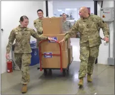  ?? PETE BANNAN - MEDIANEWS GROUP ?? Air Force and Air National Guard troops take the care packages for shipment to troops all over the world.