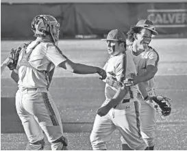  ?? KENNETH K. LAM/BALTIMORE SUN ?? Calvert Hall’s Lamar King, from left, Patrick Genco and John Harris celebrate a 7-6 victory over John Carroll on Tuesday.