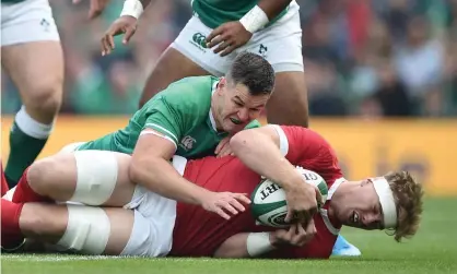  ??  ?? Alun Wyn Jones is tackled by Ireland’s Jonny Sexton in their friendly in September. Photograph: Charles McQuillan/Getty Images