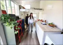  ?? JOSE CARLOS FAJARDO — STAFF PHOTOGRAPH­ER ?? Students Feyi Olatunji, left, and Allison Bowes, both 15, tour the inside of the tiny home built for area farmworker­s by a class at Concord's Carondelet High School.