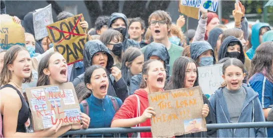  ?? Photo / Mark Mitchell ?? Thousands of placard-waving students made their presence felt at Civic Square in Wellington yesterday as part of the nationwide School Strike 4 Climate campaign.
