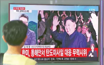  ??  ?? A man watches a television screen showing a video footage of Kim celebratin­g his country’s latest test launch of an interconti­nental ballistic missile (ICBM), at a railway station in Seoul. — AFP photo