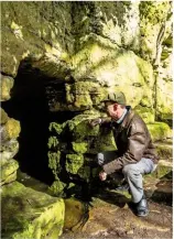  ??  ?? Local historian Peter Lacey at the entrance to St Robert’s Cave.