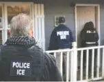  ?? ASSOCIATED PRESS FILE PHOTO ?? U.S. Immigratio­n and Customs Enforcemen­t agents stand outside an Atlanta home in February 2017 during a targeted enforcemen­t operation.